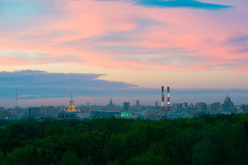 Fototapeta na wymiar The buildings of Moscow city center at sunset time. Industrial metropolis. The clouds painted by sunset above Moscow,evening in Russia.