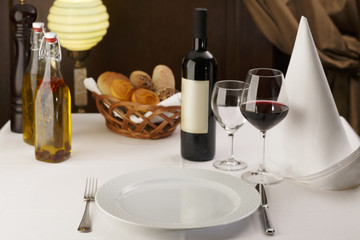 Meal setting arranged in elegant way, Wine with wineglasses and silverware, Selective focus with soft light