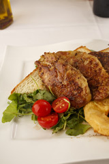 Chicken with breaded pineapple arranged on a plate, Traditional dish in elegant setting, Selective focus with soft light