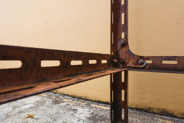 rusty nut and bolt locked with rust on rusty Slotted Angle Steel