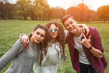 Fototapeta premium Three youngster posing in park