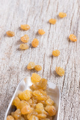 Dried yellow raisin fruits on  wood background