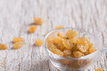 Dried yellow raisin fruits on  wood background