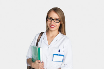 Young woman in white uniform holding cardboards