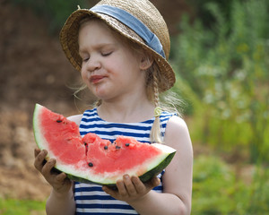 Funny little kid with a big watermelon. Funny face, great emotion.