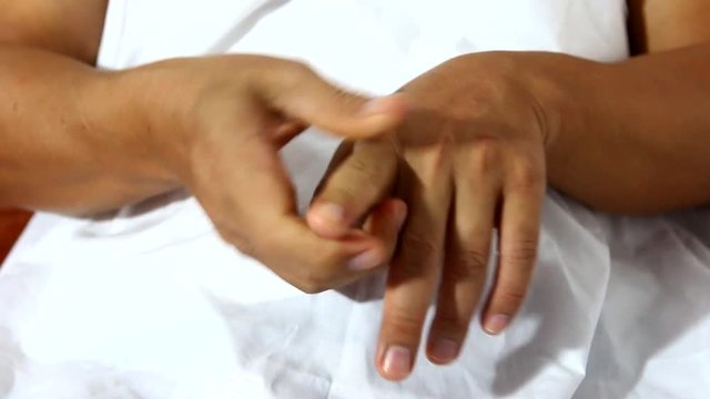 man massaging  his finger