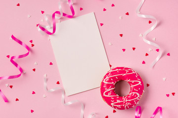 Donuts with icing on pastel pink background with copyspace. Sweet donuts.