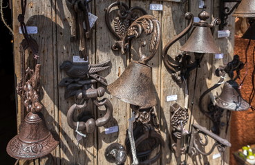 Old fashioned iron door bells and door handles for sale. Roussillon, Provence, France