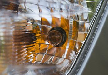 Close up of the headlight of a car, daylight photo