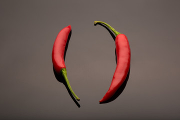 Red Hot Chili Peppers isolated on a dark reflective background