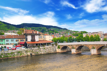 Fototapeta na wymiar View of the Latin bridge, one of the oldest bridges of Bosnia and Herzegovina, runs through the Milyacka River in Sarajevo, Bosnia and Herzegovina