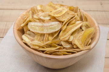  sweet banana crisps on wooden bowl