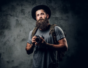 A man holds compact photo camera.