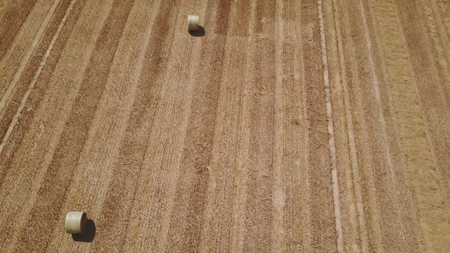 drone overflight field with hay bales.