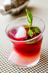 Malibu Sunset Cocktail with mint leaves..