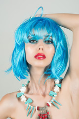 Woman in blue wig with fashionable makeup.