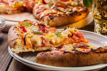 Slices of pizza with bacon, paprika and corn