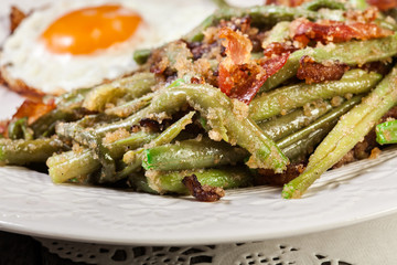 Healthy sauteed green beans with bacon and fried egg