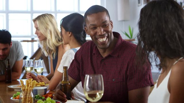 Group Of Friends Enjoying Dinner Party At Home Together