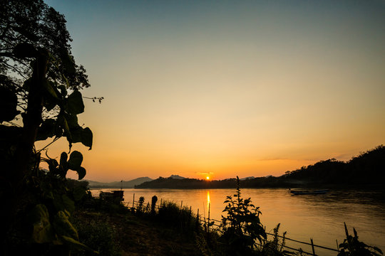 Tropical sunset above Mekong Laos