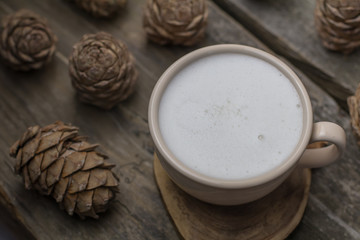 Obraz na płótnie Canvas Coffee with pine nuts cedar vegan cruelty free milk on the background of siberian cedar pine cones