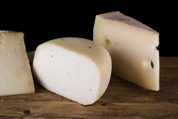 variety of Italian cheese on wooden cutting board