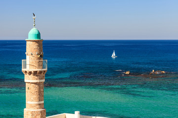 Jaffa Sea Mosque Minaret and a sailboat. Tel-Aviv,  Israel - obrazy, fototapety, plakaty