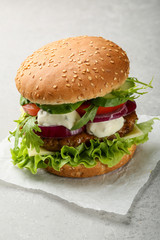 fresh tasty burger on gray background