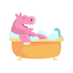 Cute cartoon hippo taking a bath, pink hippopotamus washing in foamy bathtub colorful character, animal grooming vector Illustration