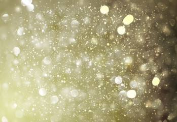 Dark Gold sparkle rays lights with bokeh elegant abstract background. Dust sparks in explosion background. Vintage or retro.