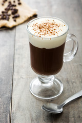 Irish coffee in glass on wooden table
