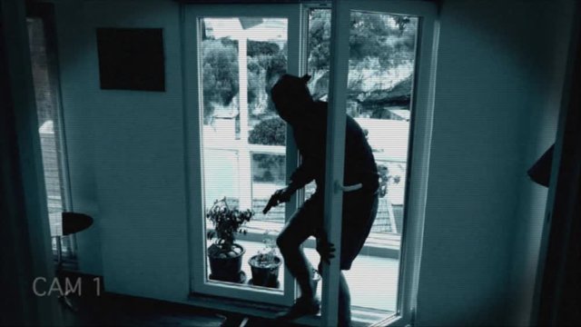 CCTV Shows Armed Burglar Entering A House. Home invader armed with a gun caught on surveillance camera