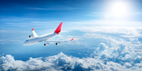Fototapeta na wymiar Airplane flying above clouds