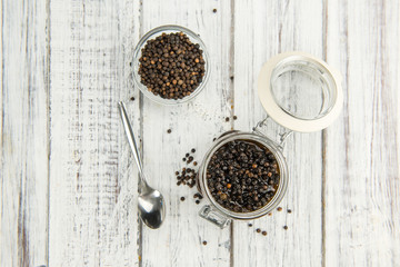 Black Peppercorns, preserved, on wooden background