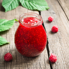 Jar with homemade raspberry jam. Ripe Berries and Leaves, Selective focus