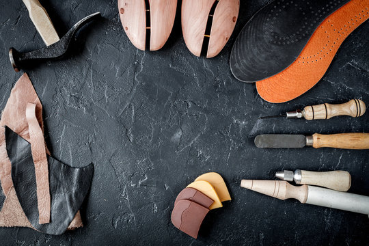 cobbler tools in workshop dark background top view mock up