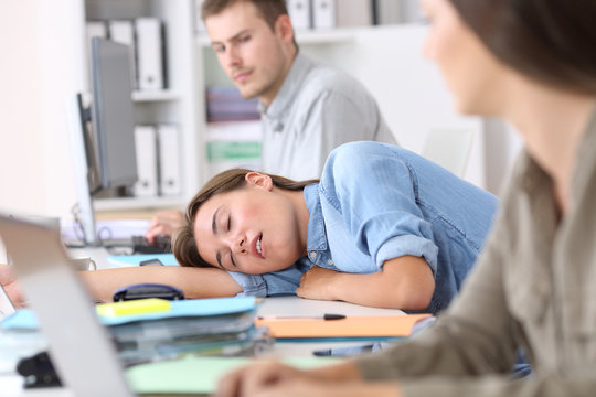 Fatigued employee sleeping at office