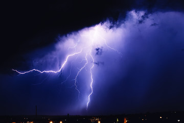 Powerful lightning over big city, zipper and thunderstorm, abstract background, dark blue sky with...