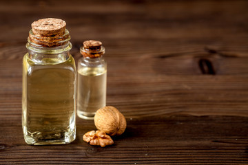 cosmetic and therapeutic walnut oil on dark wooden background