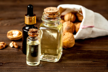 cosmetic and therapeutic walnut oil on dark wooden background