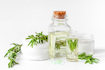 organic cosmetics with extracts of herbs rosemary on white backg