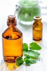 organic cosmetics with herbal extracts of mint on wooden backgro