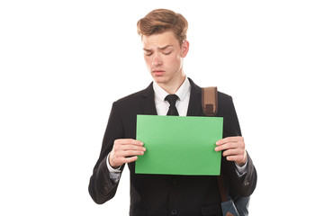 Handsome college student posing in studio with blank paper sheet