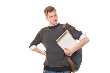 Portrait of teenage college boy holding notepad against white background