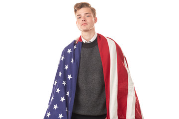 Portrait of male university student with American flag over his shoulders