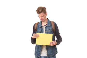 Portrait of schoolboy posing with blank paper against white background