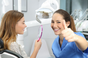 Satisfied client and dentist checking results