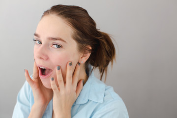 Young woman touching cheeks self-massage