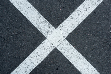top view of white parking lines on grey roadway background