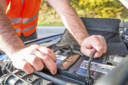 Man controlling car battery, close-up